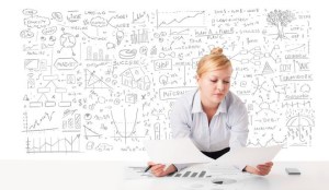 Pretty young businesswoman planning and calculating various business ideas